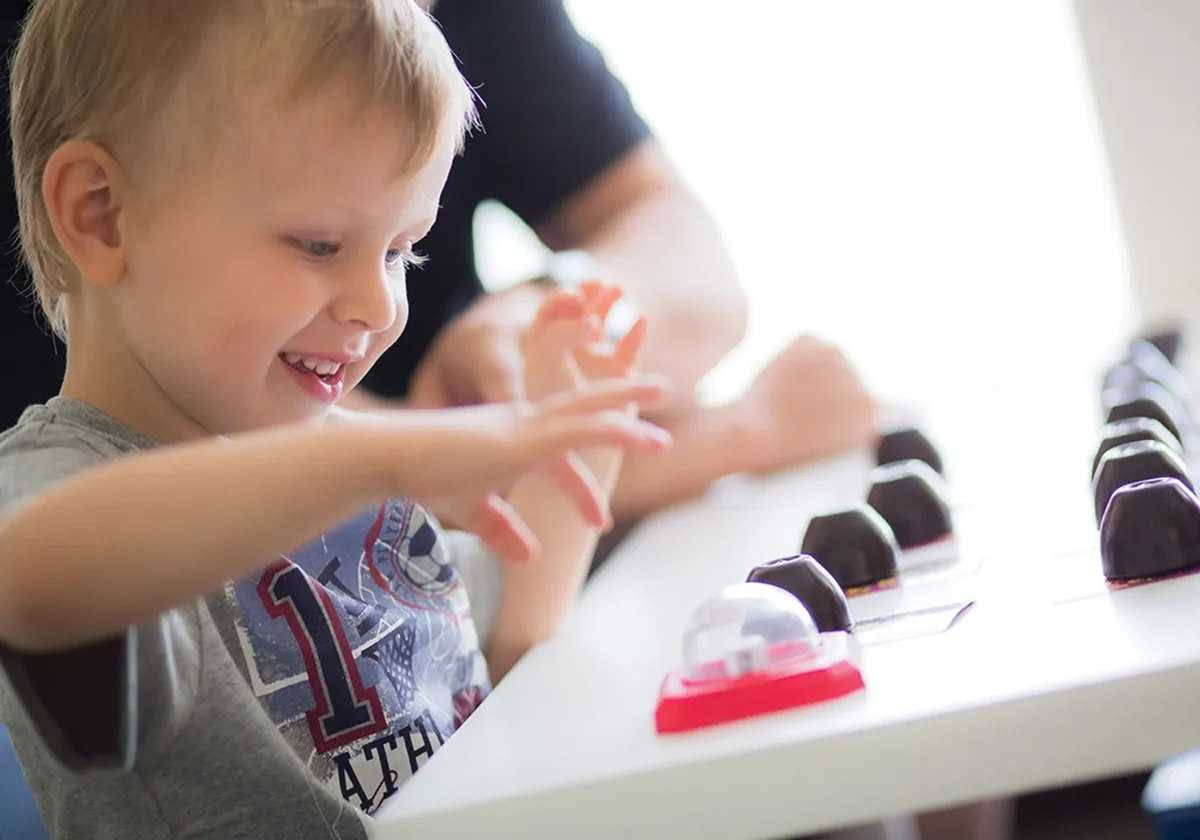 child using scissors during an occupational therapy session