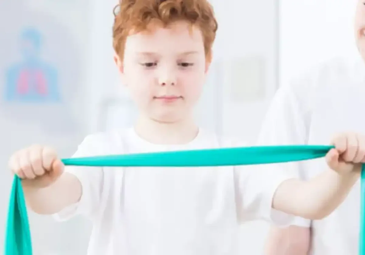 child practicing balance with a pediatric physical therapist