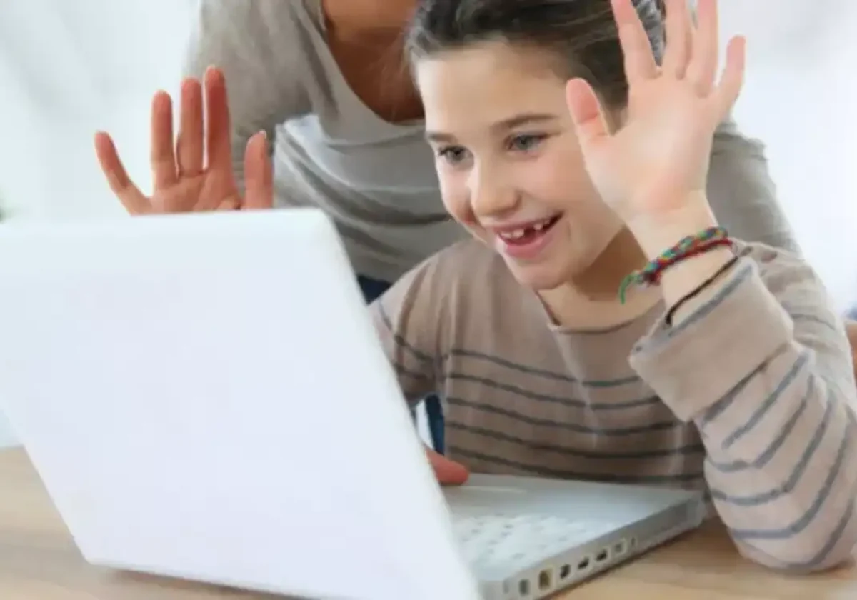 child in an online teletherapy session at home